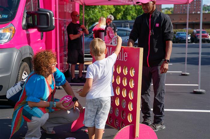 A child plays in the T-Mobile section during the AIU Back-to-School Celebration